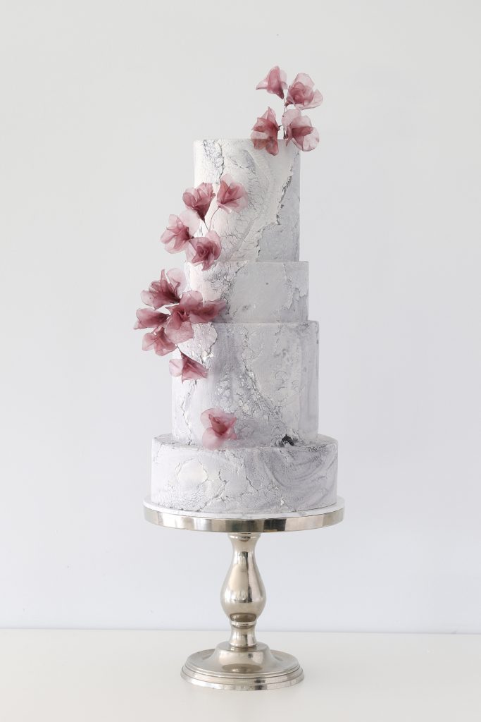 Rice paper flowers on an aged stone wedding cake Brisbane